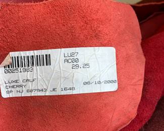 Several EXTRA LARGE pieces of upholstery cowhide leather in beautiful colors of red, green, blue, & brown. We believe this leather is from Baker Furniture and is extremely high quality. 