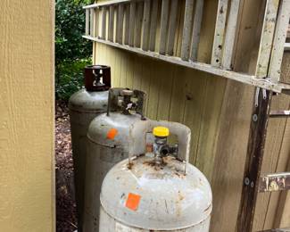 Empty canisters and extension ladder