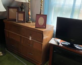 Mid-century modern dresser, matching tall dresser located in another bedroom.