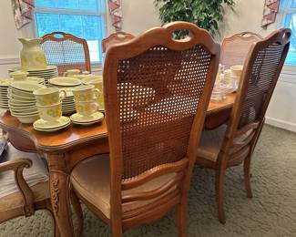 French Provincial dining room table w/ leaf and 6 caned chairs.