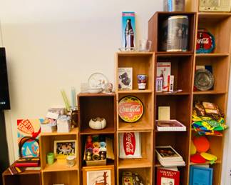 New old stock NOS, coca cola signs, samples, colorful vintage aprons and potholders, children's decor and dinner set, golfing ice bucket and trash can, original textured painting of shack house is quite good, colorful miniature spittoons', old radio, Imperial and American glass reference books, NIB NOS items