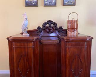 Antique NOLA side board with zinc lined drawer. Great pull out shelving and shelves inside.
Large porcelain cockatoo statue, vintage oil paintings,