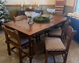 Custom  made farm table with iron eyelets. The frame is iron with iron twisted legs. Very unique. 