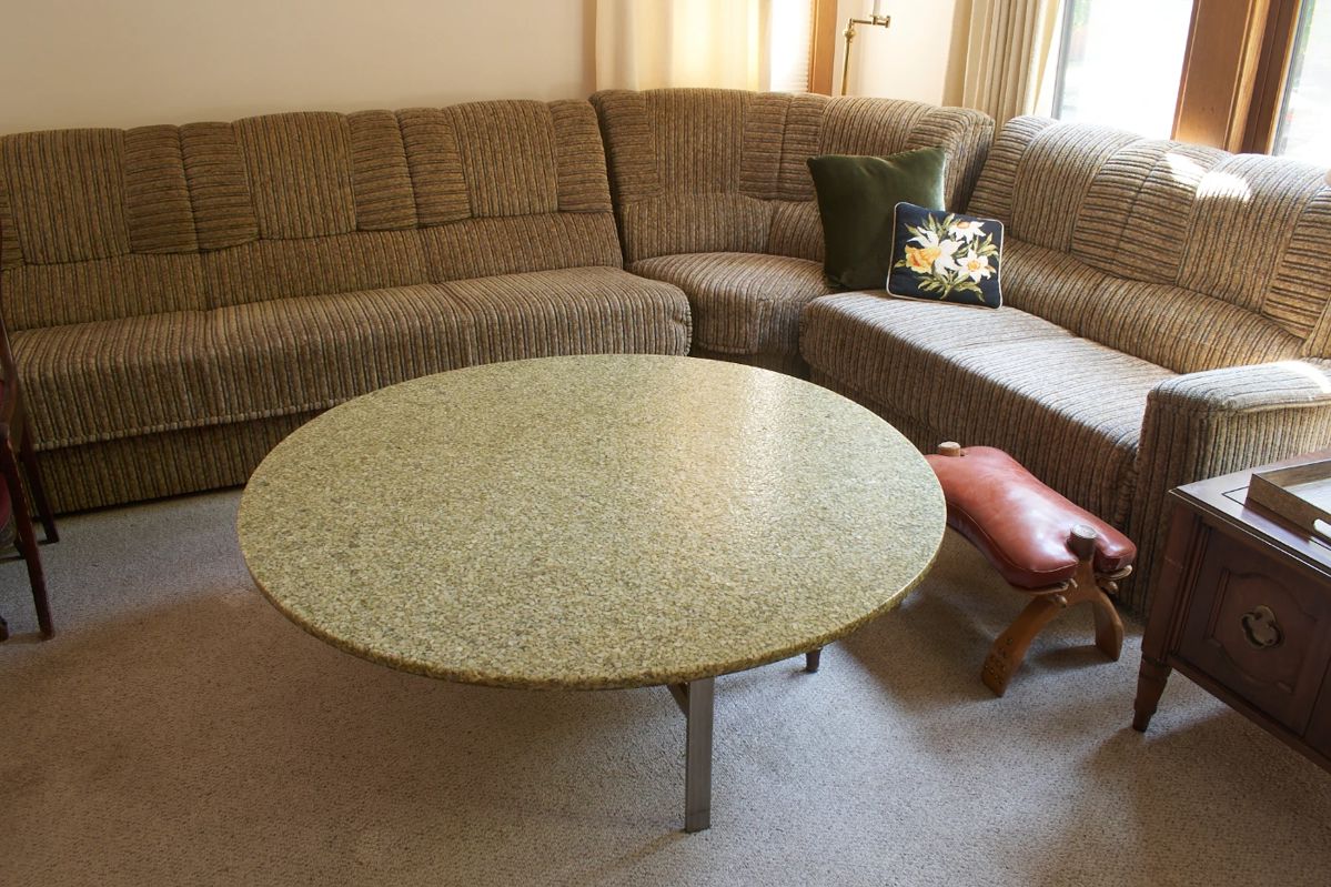 Sectional wrap around sofa, vintage round coffee table, leather covered ottoman/footstool