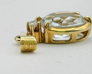Closeup of 14kt gold pendant with clear stone