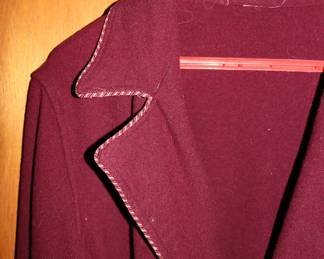 Closeup of maroon robe with piped edging and belt