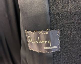 Elisberg Original label shown inside women's black coat, lined, boucle texture material, fur collar