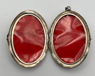 Interior of vintage silver locket with young girl's silhouette on front