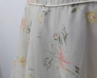 Closeup of women's short sleeved dress, floral pattern, full skirt