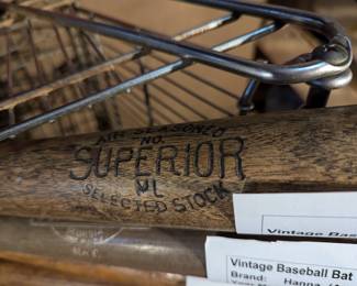 Closeup of 1930s-1050s Vintage baseball bats including ones by Superior, Hanna, Grier Mfg. Co., J. C. Higgins, Wilson