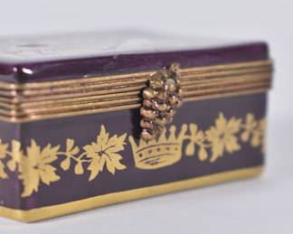 Closeup of Limoges France porcelain enameled lidded box - a wine crate with wine bottles inside