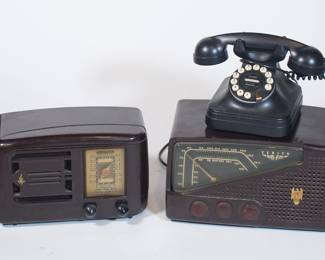 Closeup of vintage radios and vintage black Grand Phone Flash Redial PF Products landline phone. Radio on left is 1940s Emerson bakelite radio model 336.