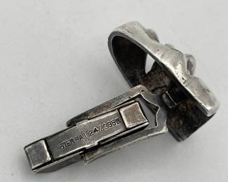 Closeup of vintage sterling silver cufflinks with comedy and tragedy masks representing the performing arts