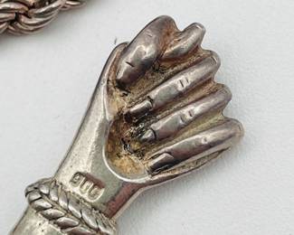 Closeup of sterling silver necklace with Mano Figa charm