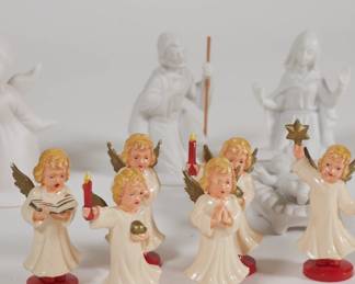 Close up of Nativity scene figures of Joseph, Mary and infant Jesus; group of angel/choir figurines