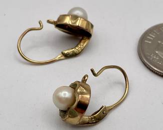 Closeup of 8kt gold pierced earrings with pearls in round cinquefoil frames