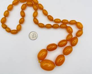 Another view of graduated size amber bead necklace