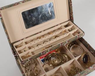 Women's jewelry box containing rings, necklaces, earrings, bracelets, and brooches 