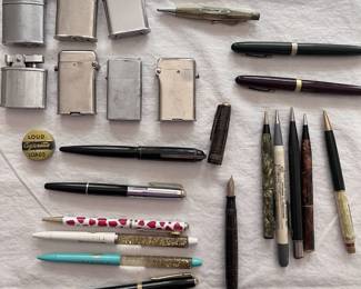 Collection of vintage lighters, pens, and mechanical pencils