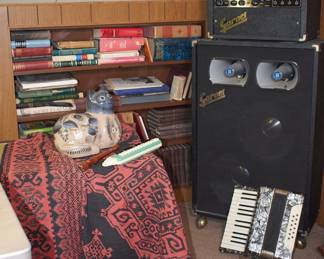Books, accordion, and vintage Garnet Pro Amp Head and Garnet 2 horn cabinet