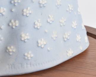 Closeup of Hummel TMK-2 Flower Madonna figurine in glass bell jar with wooden base