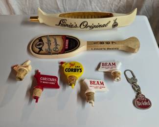 Beer and liquor branded bottle openers, pourers, and taps