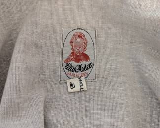 Closeup of label inside women's German dirndl dress, long sleeved, with apron
