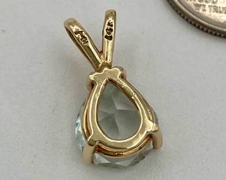 Back of 14kt gold pendant with pear-shaped blue stone