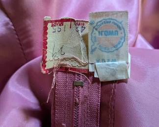 Inside zipper of women's v-neck pink party dress with wide sash belt