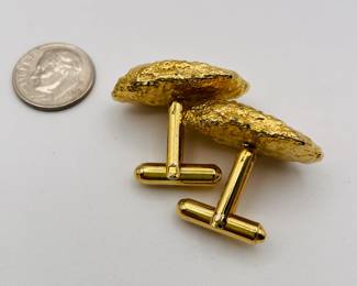 Another view of pair of cufflinks in gold toned metal, with textured gold nugget shape