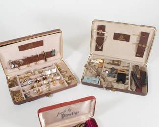 Jewelry cases containing cufflink sets and tie tacks and pins, antique pocket watch chains, corkscrews, bracelets, badges