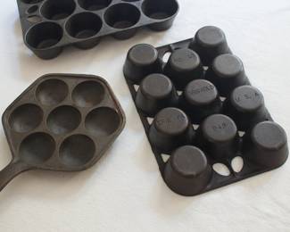 Closer look at two Griswold cast iron No. 10 muffin/popover baking pans, made in Erie, PA, along with a cast iron Aebleskiver pan