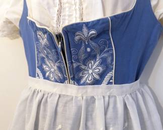 Closeup of women's German dirndl dress, embroidered, short sleeves, apron