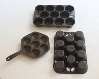 Two Griswold cast iron No. 10 muffin/popover baking pans, made in Erie, PA, along with a cast iron Aebleskiver pan