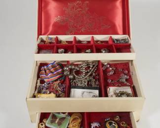 Women's jewelry box containing rings, necklaces, earrings, bracelets, and brooches 