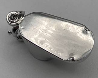 Closeup of sterling silver baby shoe charm