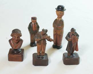 Closeup  of some carved wooden figurines including musicians