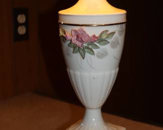 Closeup of vintage urn shape porcelain lamps with applied floral decoration, Capodimonte Style, with matched shades