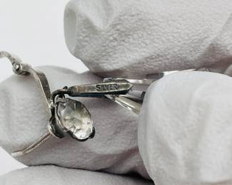 Closeup of pair of sterling silver pendant drop clip earrings