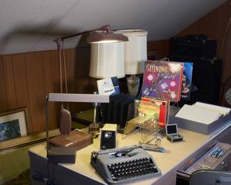 Multiple vintage and antique typewriters, 1940's desk lamps, old steel office desk
