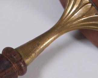 Closeup of vintage copper saucepans with lids, wooden handles, made in Italy