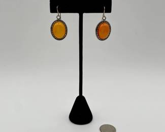 Pair of amber earrings, oval cabochon amber in rope-style silver border