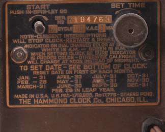 Closeup of back of vintage Hammond Clock Company, Chicago Ill, Art Deco Skyscraper Bakelite electric clock with date function, serial nbr K194763