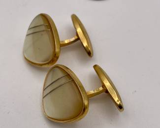 Another view of pair of cufflinks, gold tone metal, agate style stones with thin silver wires