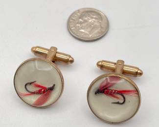 Pair of cufflinks in gold tone metal, with red fishing flies inside clear dome 