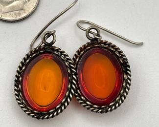 Reverse of pair of amber earrings, oval cabochon amber in rope-style silver border