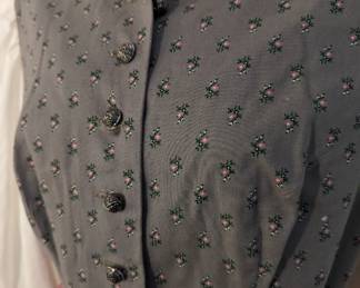 Closeup of bodice of women's German dirndl dress, long sleeved, with apron