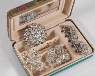 Small jewelry box with rhinestone clips and brooches