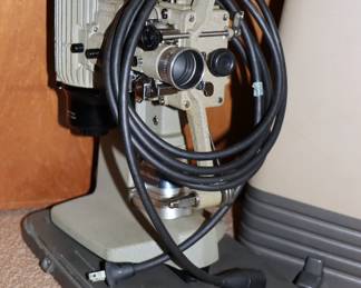 Closeup of vintage Bell & Howell film projector with hardshell carrying case