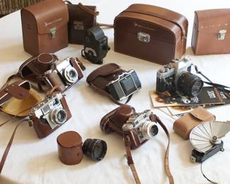 Vintage cameras and leather cases including Paxette, Agfa, Bell & Howell, Canon, and Zeiss Ikon